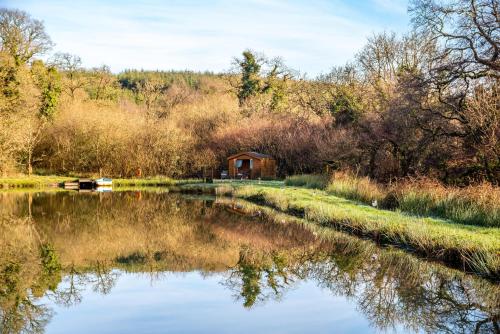a small cabin on the side of a river at Finest Retreats - The Tree House - Eco-Friendly, Back to Nature Experience in Germansweek