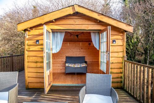 a wooden gazebo with a bed in it at Finest Retreats - The Tree House - Eco-Friendly, Back to Nature Experience in Germansweek