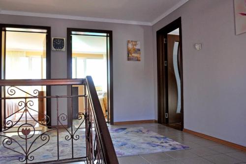 a staircase leading to a room with two doors at Вила в с. Габарево, Долината на Розите. in Gabarevo