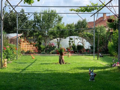 a garden with a toy animal in the grass at Вила в с. Габарево, Долината на Розите. in Gabarevo