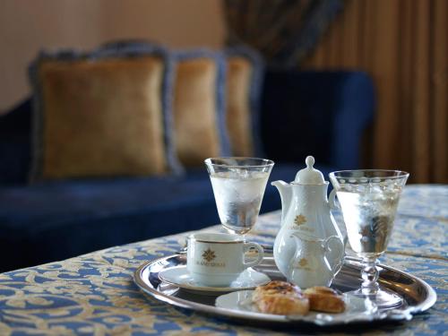 a table with a tray with a tea set and a tea pot and a cup at Grand Serai Congress and Spa in Ioannina