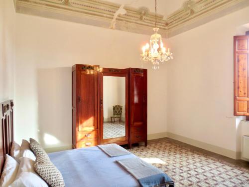 a bedroom with a bed and a chandelier at Villa Anna in Torre del Lago Puccini