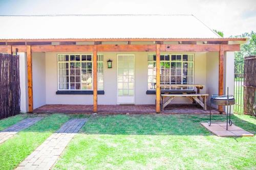 a screened in porch of a house with a picnic table at Modern Farm in Lichtenburg