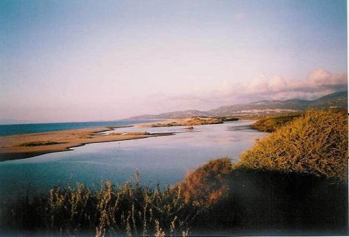 a body of water with an island in the distance at La Vignaredda - Residenza di Charme in Aggius