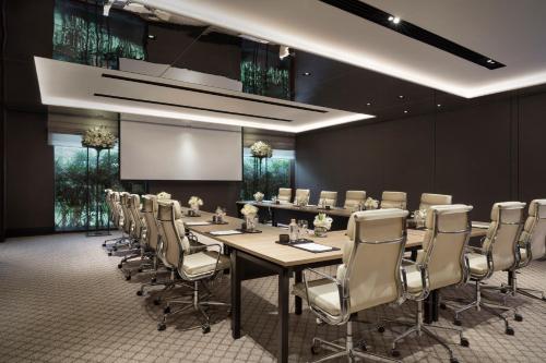 a conference room with a long table and chairs at The Sukhothai Bangkok in Bangkok