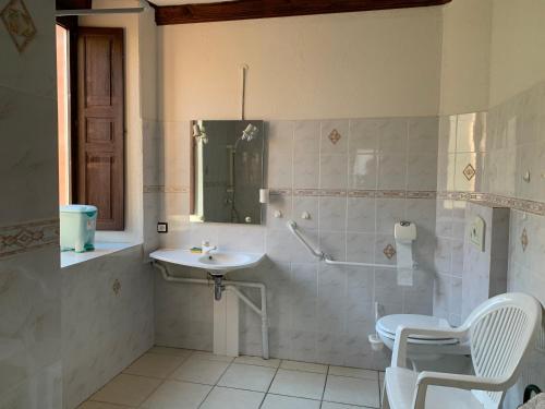 a bathroom with a sink and a toilet and a mirror at Aucairn in Château-Verdun