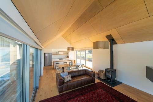 a living room with a couch and a table at Villa Kaki in Lake Tekapo