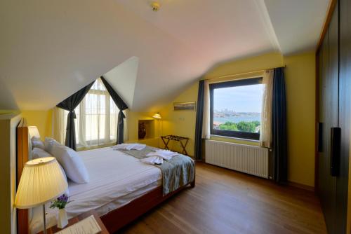 a bedroom with a large bed and a large window at Agora Life Hotel in Istanbul