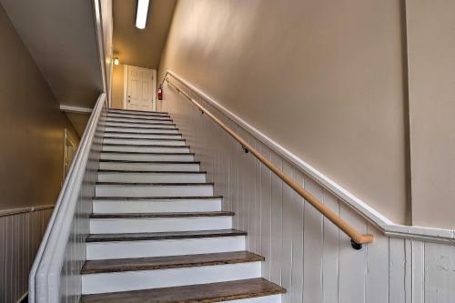 a stairway in a building with white stairs at Chic Main Street Retreat Less Than 7 Mi to KY Horse Park! in Georgetown