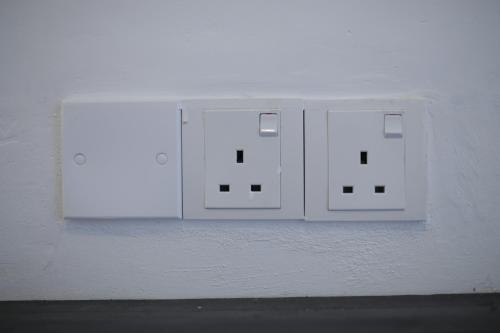 a white light switch on a white wall at Aman Dan Laut in Perhentian Island
