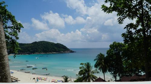 a view of a beach with boats in the water at Aman Dan Laut in Perhentian Island
