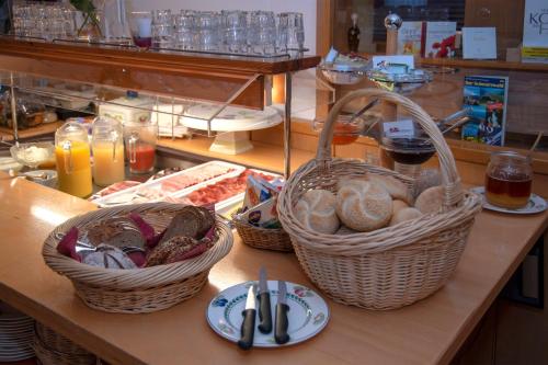 a wooden table topped with a basket filled with food at Stadthotel Pfeffermühle in Gengenbach