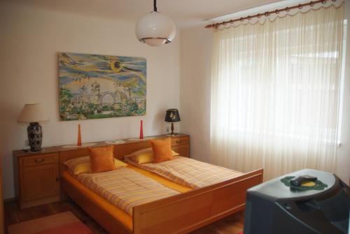 a bed in a room with a window at Guesthouse 7even in Mostar