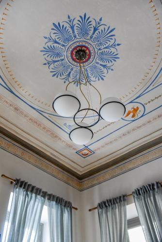 a coffered ceiling with a painting on it at Erst Guest House in Athens