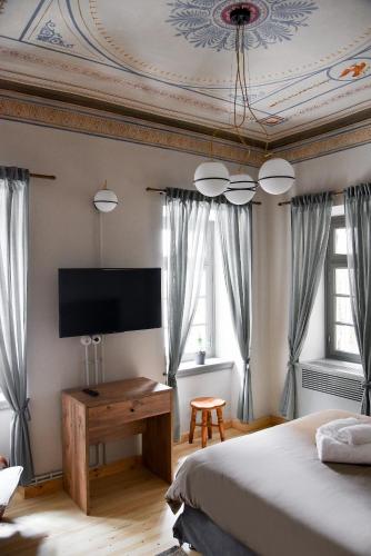a bedroom with a bed and a flat screen tv at Erst Guest House in Athens