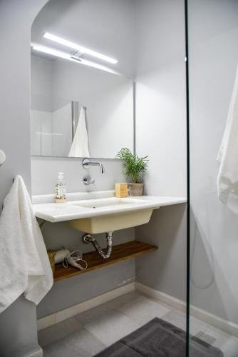 a bathroom with a sink and a mirror at Erst Guest House in Athens