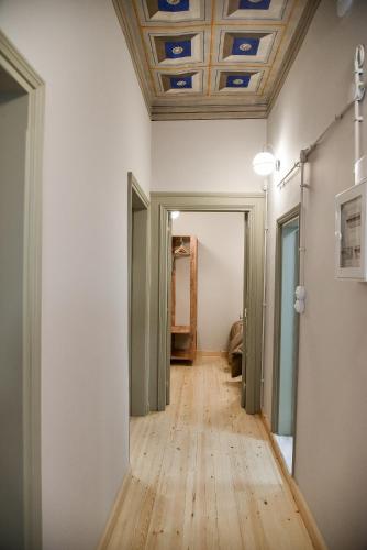 an empty hallway with a wooden floor and a ceiling at Erst Guest House in Athens