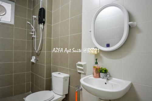 a bathroom with a toilet and a sink and a mirror at Bandar Saujana Putra BSP 21 AZFA Suite [FREE WiFi] in Jenjarum