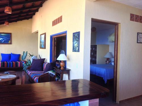 a living room with a couch and a bed at Casas Garcia in Yelapa