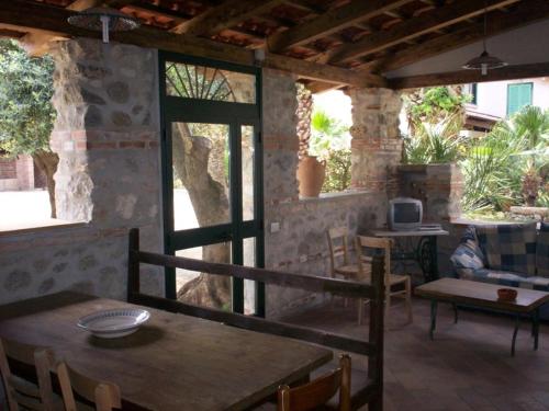 a patio with a table and chairs and a tv at Villa Marianna in Ricadi
