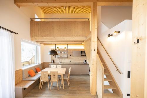a kitchen and dining room with a loft conversion at ALPRIMA Aparthotel Hinterstoder in Hinterstoder