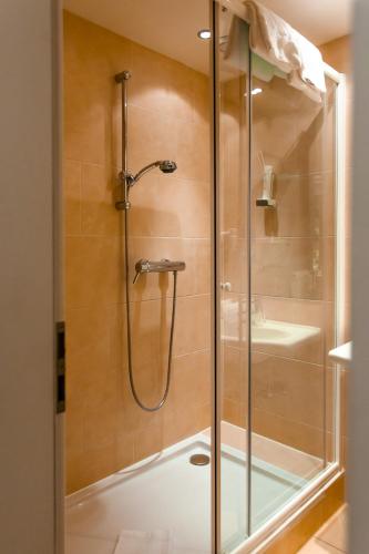 a shower with a glass door in a bathroom at Hotel Parks in Velden am Wörthersee