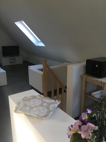 a room with a white table and a skylight at Ferienwohnung FENJA in Bonerath