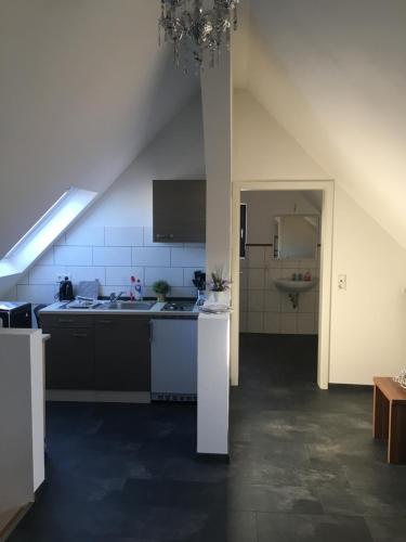 a kitchen with a sink and a counter top at Ferienwohnung FENJA in Bonerath