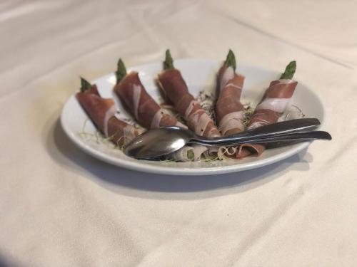 a plate of food on a table with a plate of food at Sa Dom'e Malloru in Burcèi
