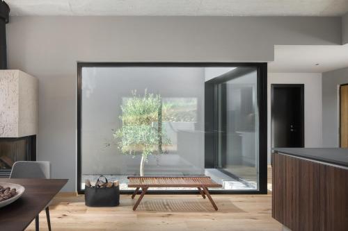a living room with a bench in front of a window at Villa Ulmus in Karojba