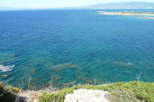 a view of the ocean from a bluff at "Sutt'e su sole" - Vacanza nel cuore della Sardegna in Siamanna