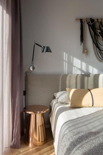 a bedroom with a bed and a table and a lamp at Villa Ulmus in Karojba