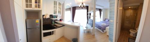 a small kitchen with a sink and a counter at Cozy near beach 200m with toproof pool at Patio Bangsaen in Bangsaen