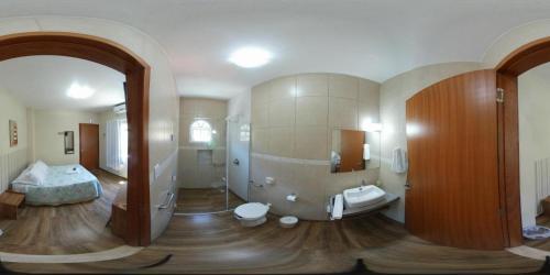 a bathroom with a sink and a toilet in a room at Pousada Mar de Almirante in Penha