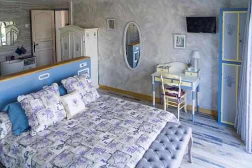 1 dormitorio con cama, mesa y escritorio en Hôtes'Antic Provence, en Lorgues