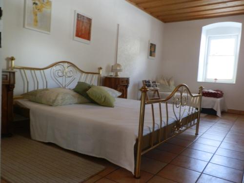 a bedroom with a bed with white sheets and a window at Parkvilla Mallnitz in Mallnitz