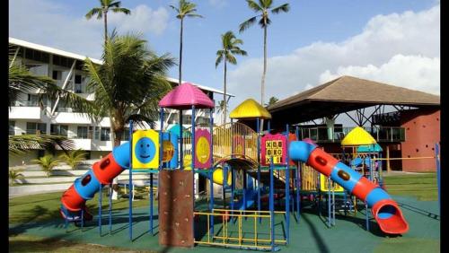 a colorful playground in a park with a slide at Ancorar Flat Resort Porto de Galinhas in Porto De Galinhas