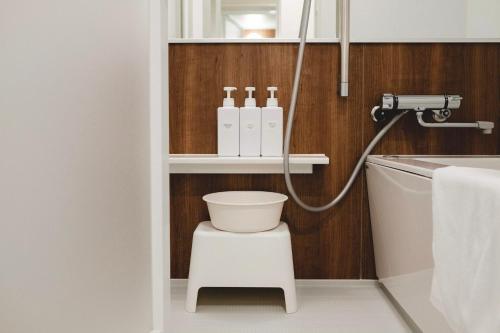 a bathroom with a white toilet and a sink at SO Kyoto Fushimi Inari in Kyoto