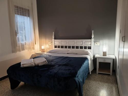 a bedroom with a large bed with two towels on it at La Ribera, Apartament amb vistes al mar R2 in Port de la Selva