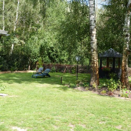 a park with a bench and a gazebo in the grass at Zur Nachtigall in Damnatz
