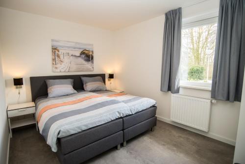 Ένα ή περισσότερα κρεβάτια σε δωμάτιο στο Vakantiewoning Hermelijn