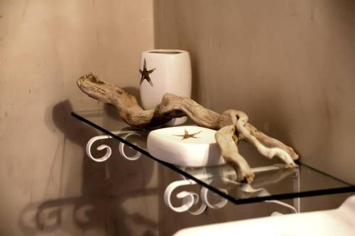 a glass table with a candle and a candle holder at NIKIS SEASIDE HOUSE in Kalymnos