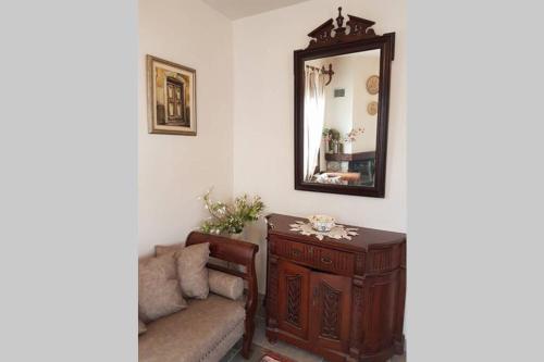 a living room with a mirror and a couch at NIKIS SEASIDE HOUSE in Kalymnos