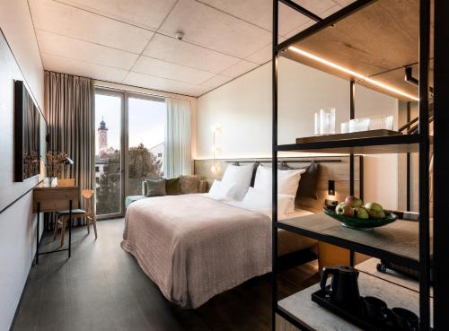 a hotel room with a bed and a desk and a room at Das Altmühltal Hotel & Restaurant in Eichstätt