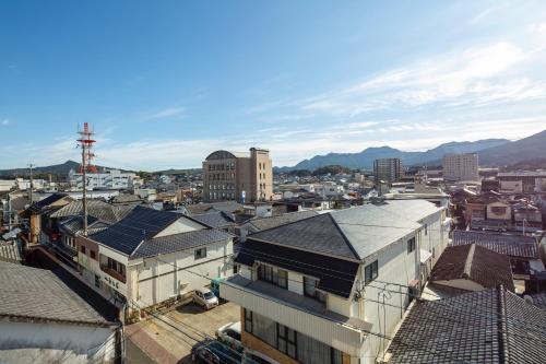 an overhead view of a city with buildings and mountains at Hotel Imari Aioibashi Bettei in Imari