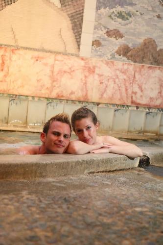 a man and a woman in a bathtub at Nogami Honkan in Beppu