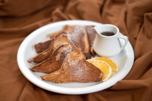 a plate of pancakes and a cup of coffee at Hotel Tikal Inn in Tikal