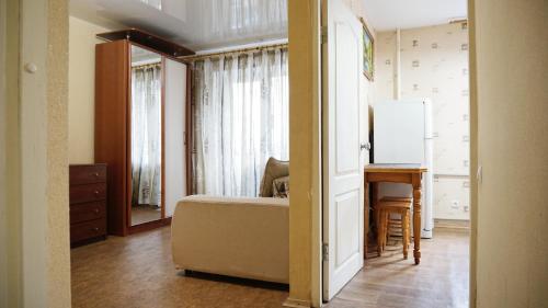 a bedroom with a bed and a desk and a mirror at Doba In Ua Hoholya Apartments in Dnipro