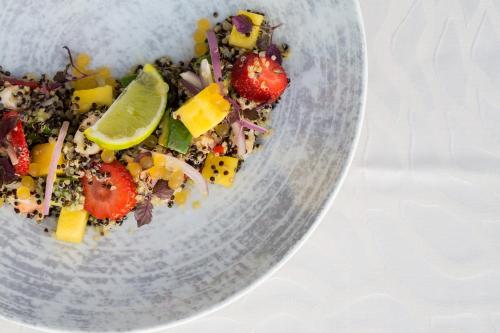 a salad in a glass bowl on a table at Divani Escape - Adults Only in Athens
