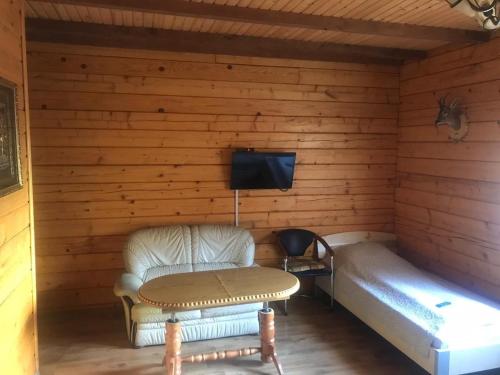 a room with a bed and a chair and a tv at Elephant in Bachina